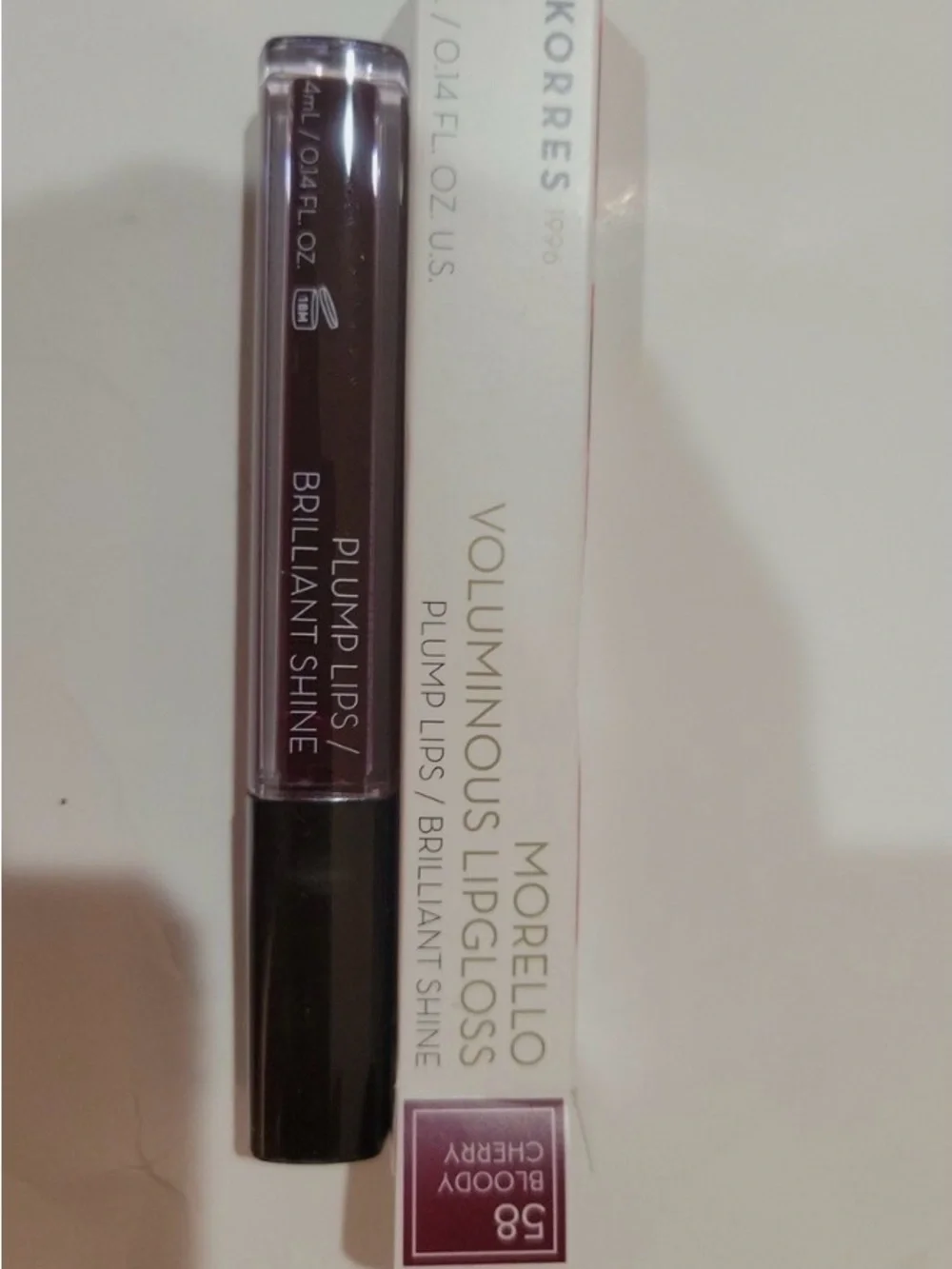 BOODY Lip Gloss - Shiny White Packaging with Red Nails Visible